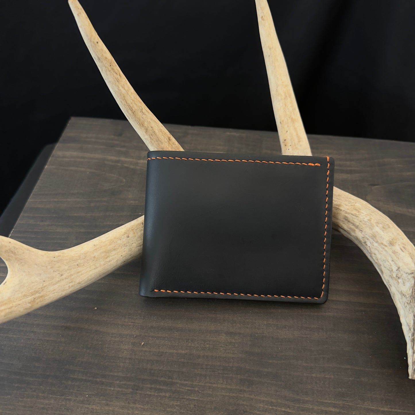Buster Bifold Wallet. Black with Orange Goat Leather Interior. Orange Stitch. #157