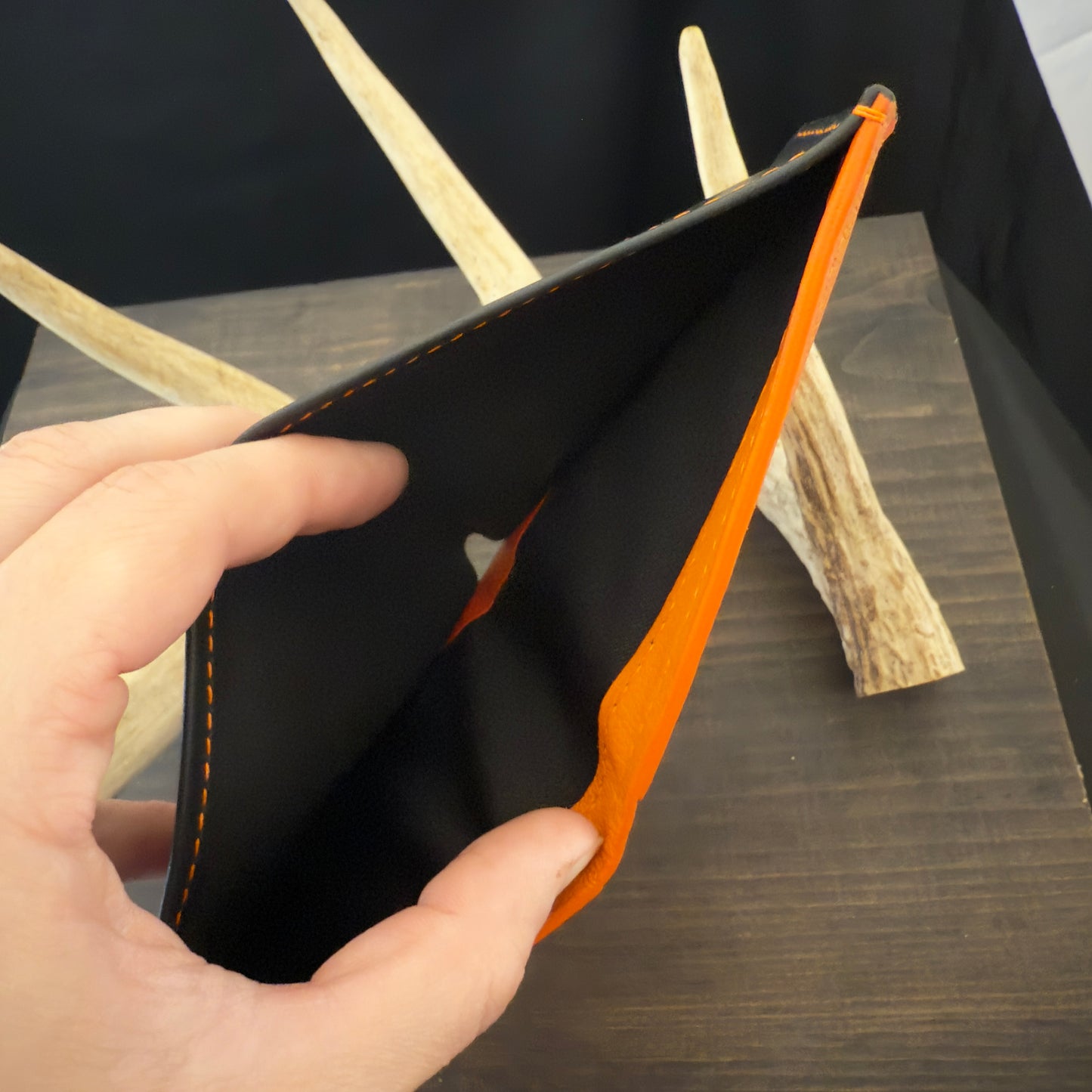 Buster Bifold Wallet. Black with Orange Goat Leather Interior. Orange Stitch. #157