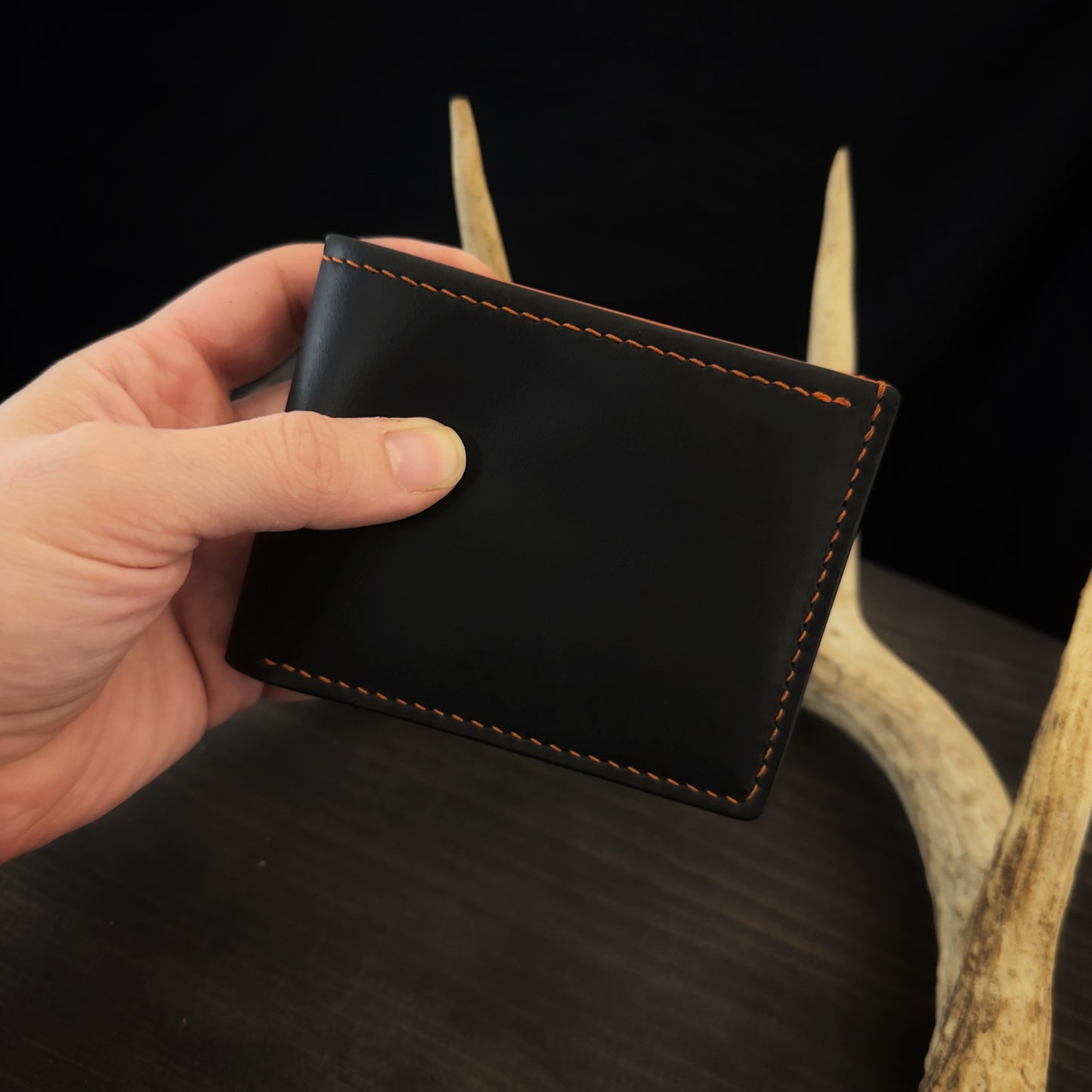 Buster Bifold Wallet. Black with Orange Goat Leather Interior. Orange Stitch. #157