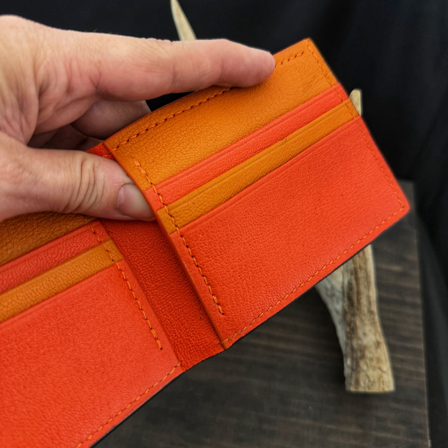 Buster Bifold Wallet. Black with Orange Goat Leather Interior. Orange Stitch. #157
