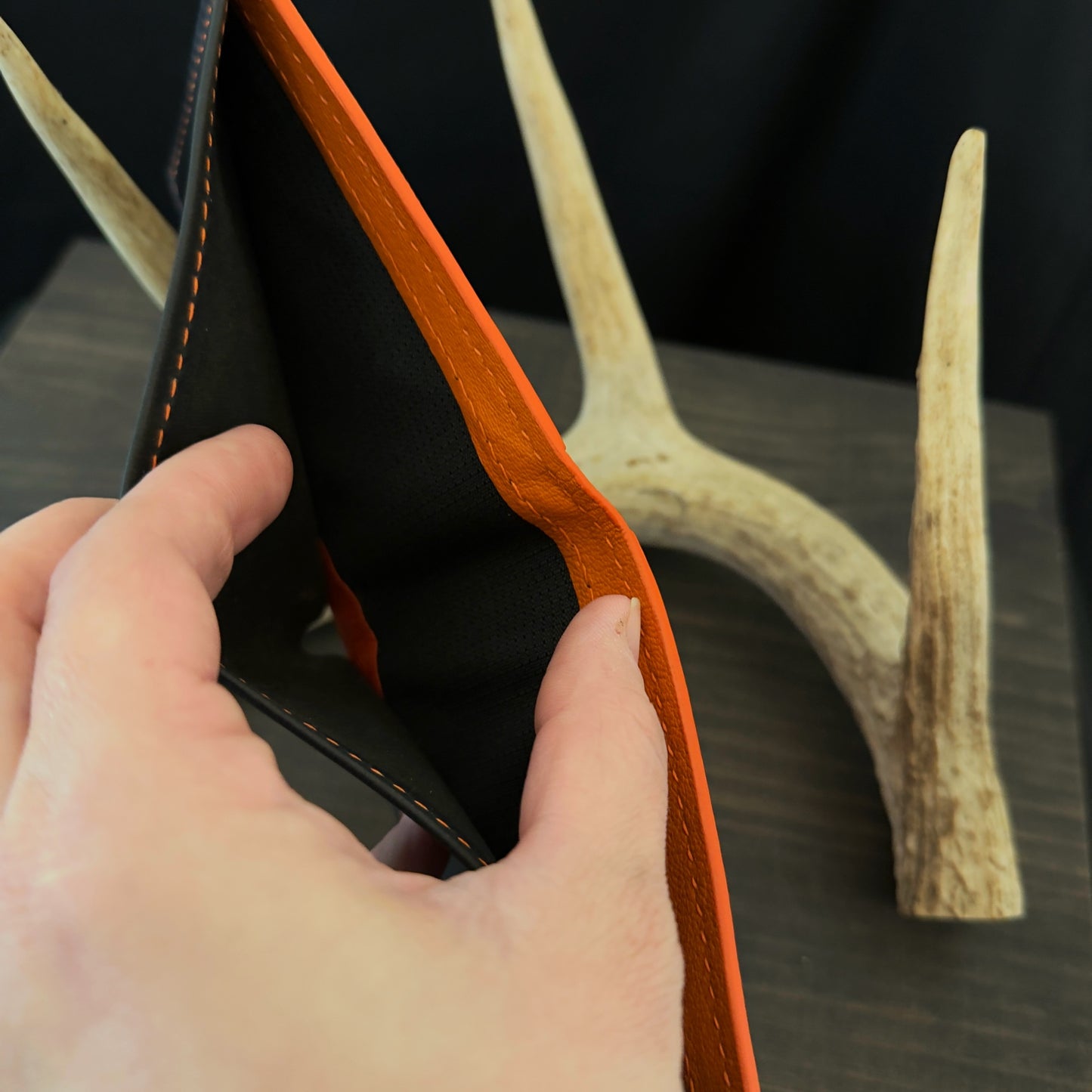 Buster Bifold Wallet. Black with Orange Goat Leather Interior. Orange Stitch. #157