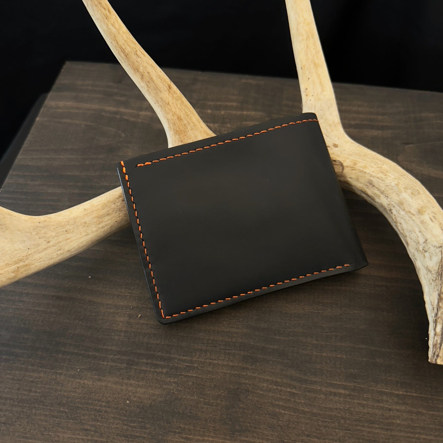 Buster Bifold Wallet. Black with Orange Goat Leather Interior. Orange Stitch. #157